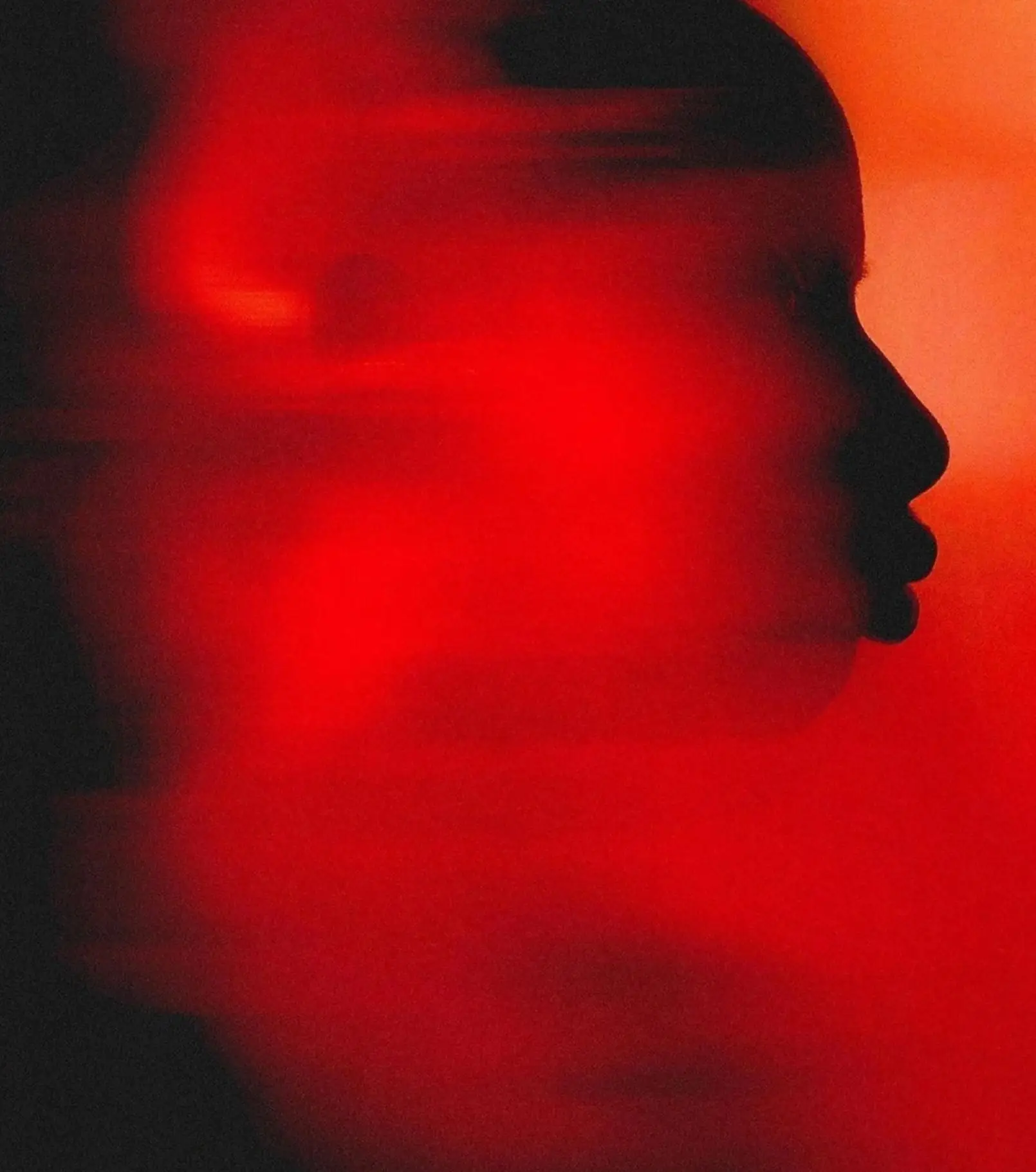 Silhouetted artist with red light